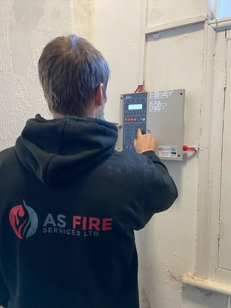 Engineer servicing a Fike fire alarm control panel